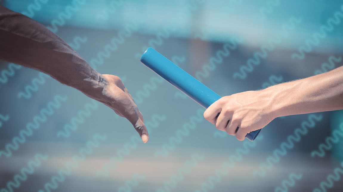 hands passing a baton